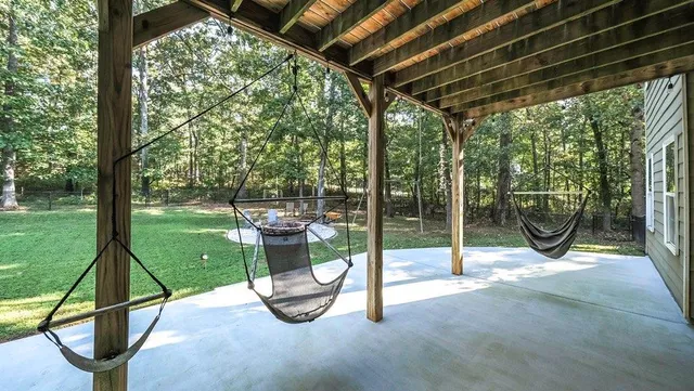 a aerial view of a house with a yard and trees