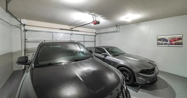 an aerial view of a house with a yard and mountain