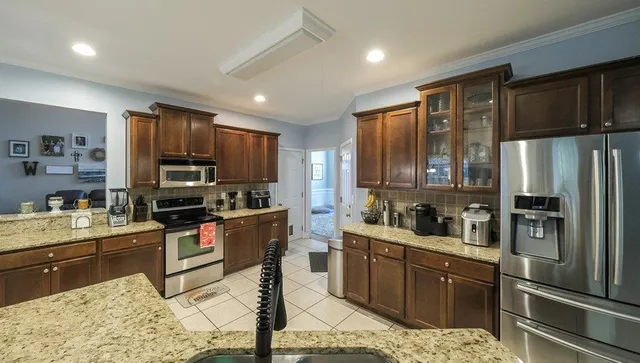 a kitchen with refrigerator cabinets and furniture