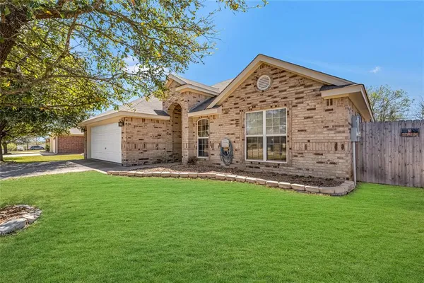 a view of a house with a yard and sitting area