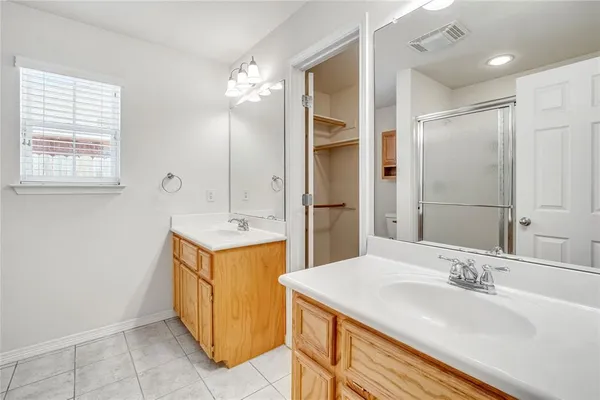 a bathroom with a sink double vanity and a mirror