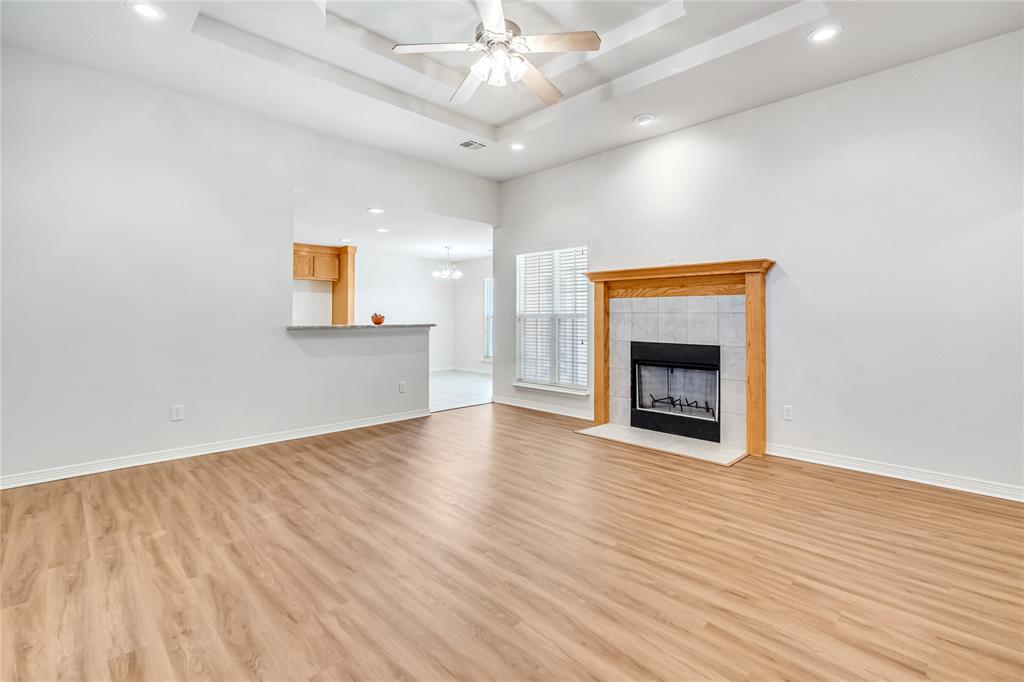 5209 Foxhill Road Temple, TX 76502 - Photo 7 of 14 a view of an empty room with wooden floor and a fireplace