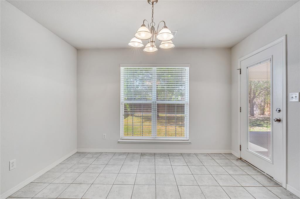 5209 Foxhill Road Temple, TX 76502 - Photo 10 of 14 an empty room with windows and chandelier