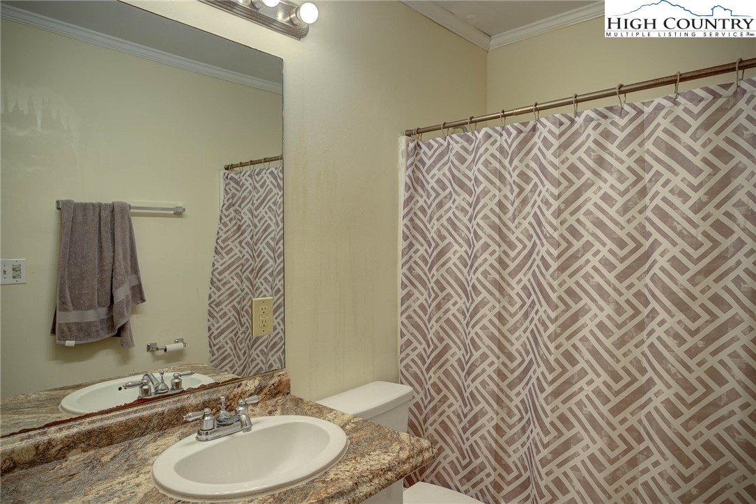 286 Faculty Street, Unit 102 Boone, NC 28607 - Photo 8 of 8 a bathroom with a sink and a mirror