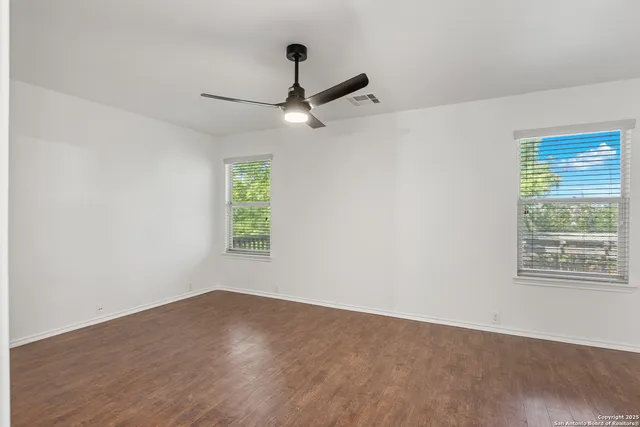 wooden floor in an empty room with a window