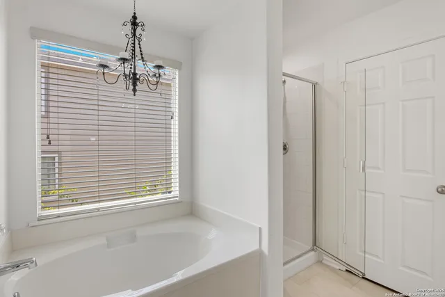 a view of a bathroom with a window a sink and dishwasher