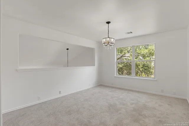 a view of an empty room with windows