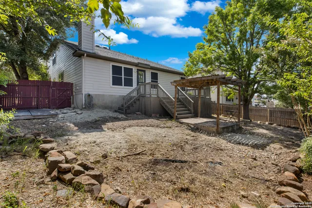 a view of a backyard with a large tree