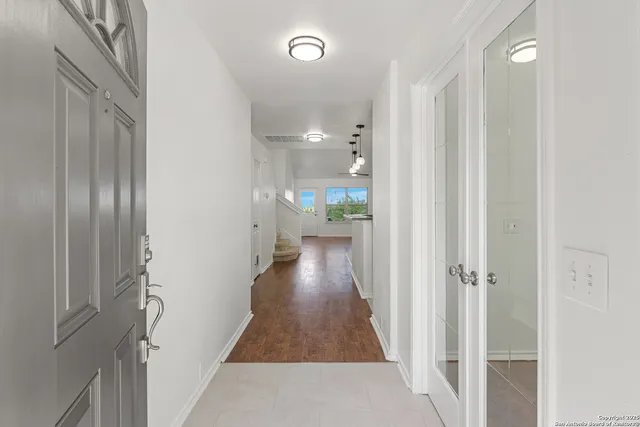 a view of a hallway with wooden floor