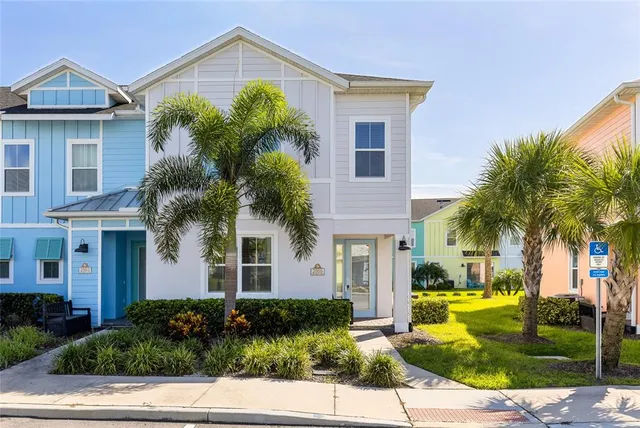 a front view of a house with garden and trees