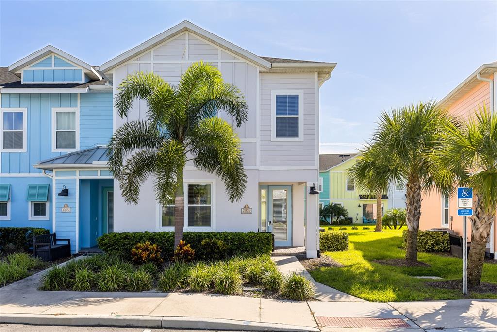 a front view of a house with garden and trees