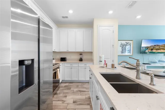 a kitchen with a sink a stove and cabinets