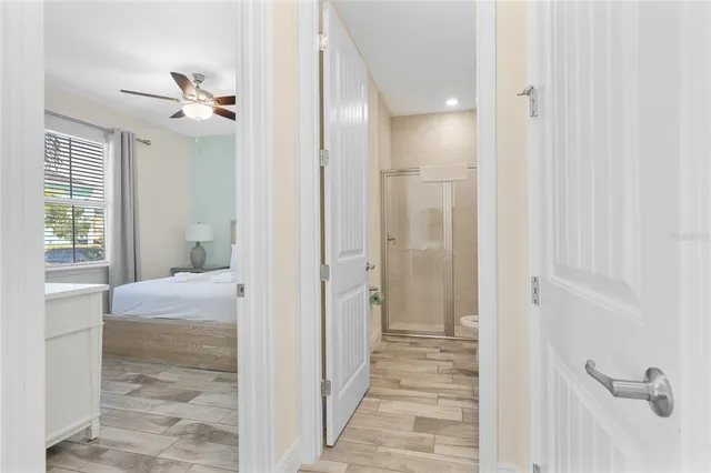 a view of a hallway with a livingroom and a bathroom