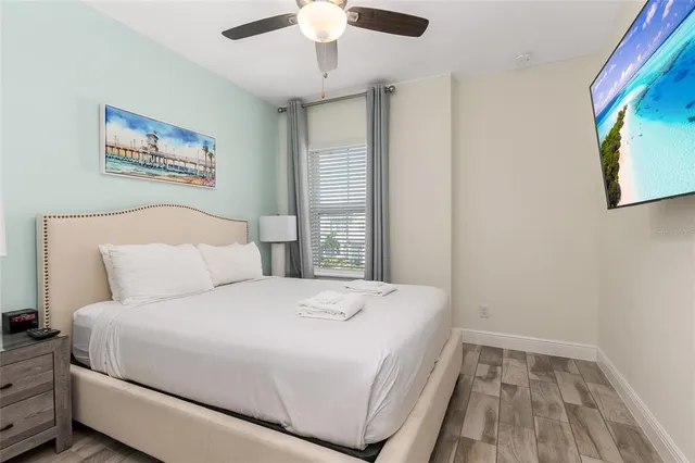 a bedroom with a large bed and a chandelier