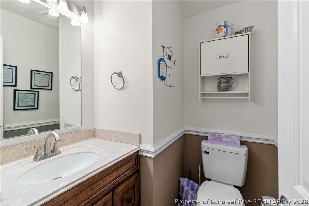 1912 Havilah Road Fayetteville, NC 28303 - Photo 10 of 14 a bathroom with a granite countertop toilet sink and mirror