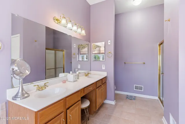 a bathroom with a shower and a mirror