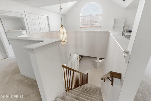 a living room with stainless steel appliances kitchen island a sink and cabinets