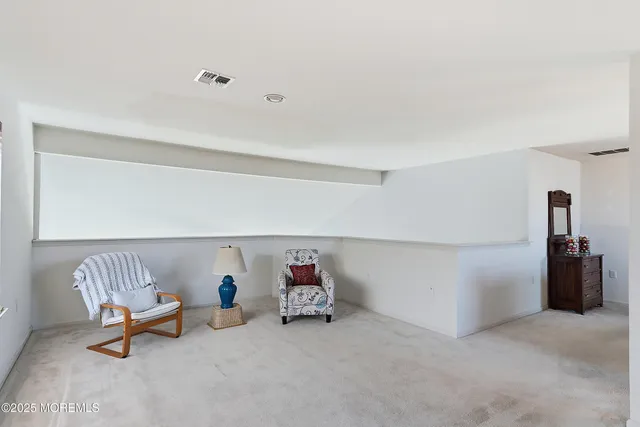 a bathroom with a toilet a sink a mirror a vanity and shower