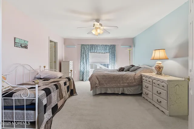 a view of a livingroom with furniture staircase and a ceiling fan