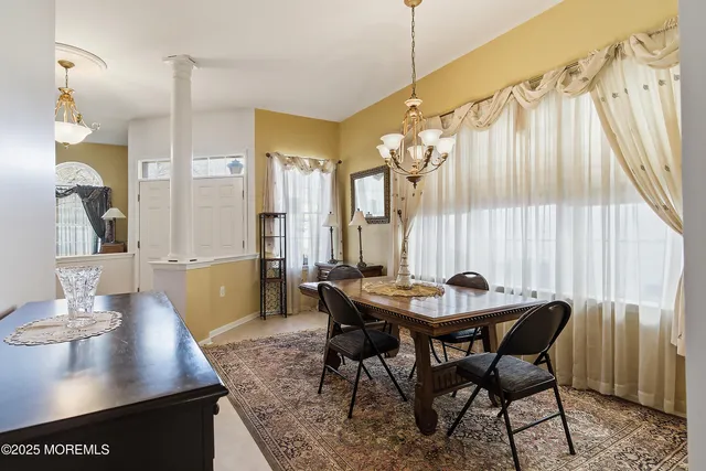 a view of a hallway with wooden floor and a living room