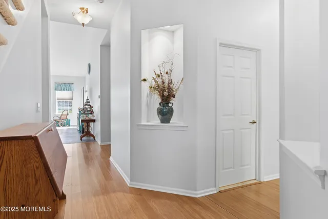 a dining room with a wooden table chairs and kitchen view