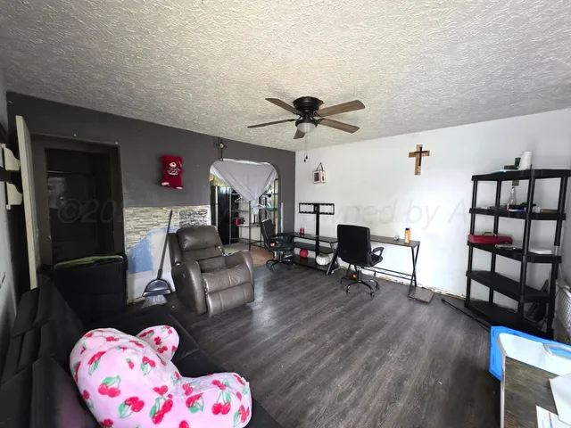 a living room with furniture and a wooden floor