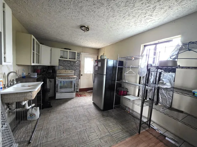 a kitchen with a refrigerator and a sink