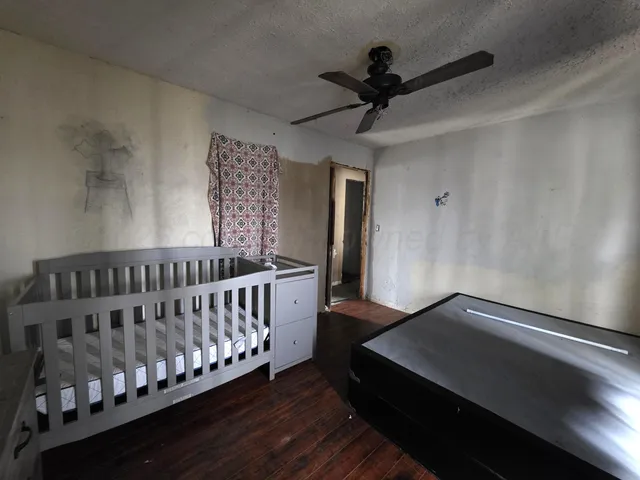 a bedroom with furniture and wooden floor