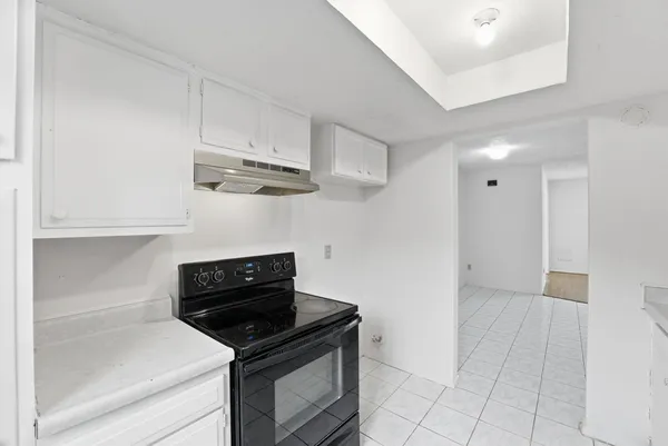 a kitchen with granite countertop a stove and a refrigerator