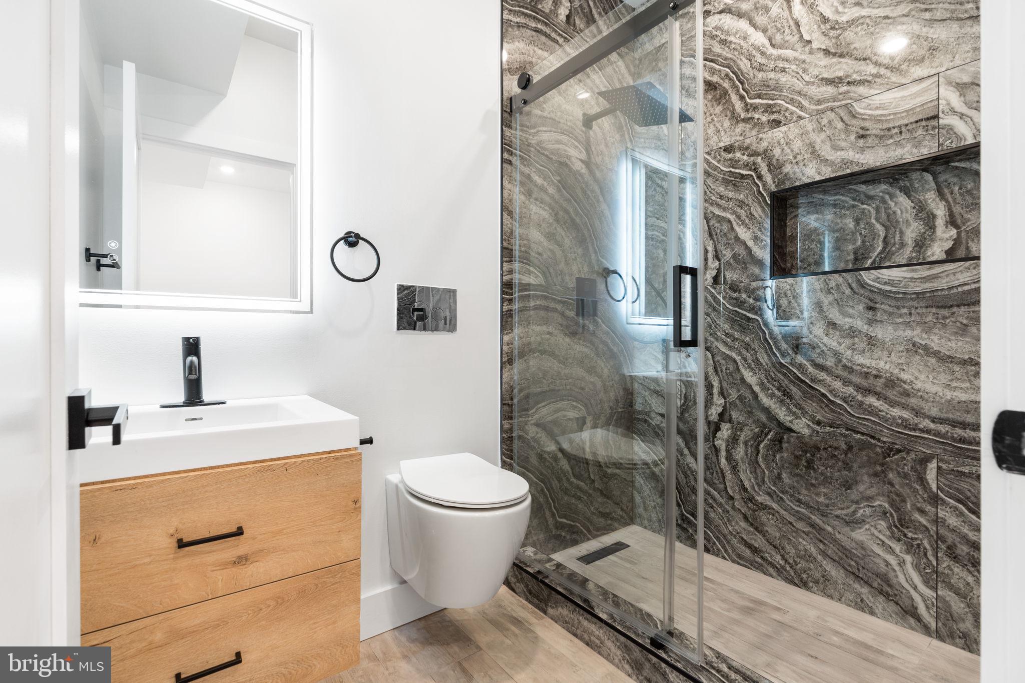 2504 41st Street Northwest, Unit 5 Washington, DC 20007 - Photo 14 of 24 a bathroom with a granite countertop sink toilet and shower