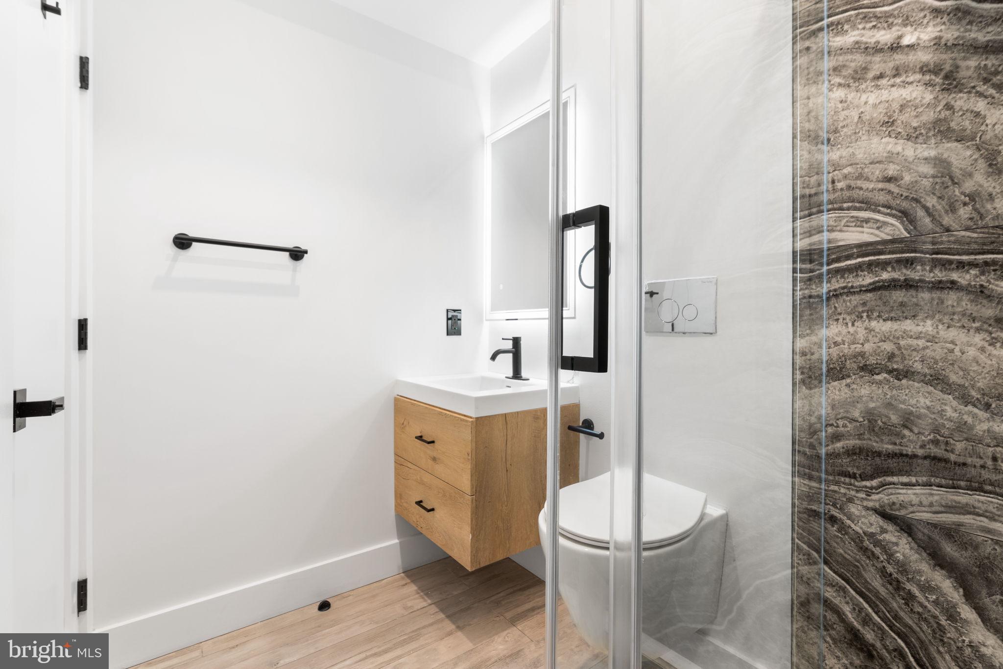 2504 41st Street Northwest, Unit 5 Washington, DC 20007 - Photo 15 of 24 a bathroom with a granite countertop toilet and a sink