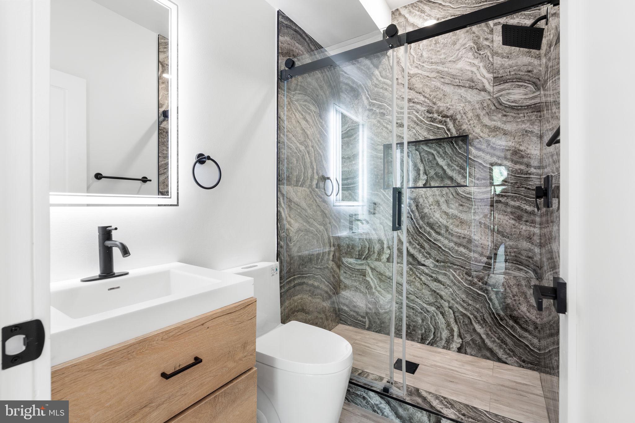 2504 41st Street Northwest, Unit 5 Washington, DC 20007 - Photo 19 of 24 a bathroom with a sink toilet and shower