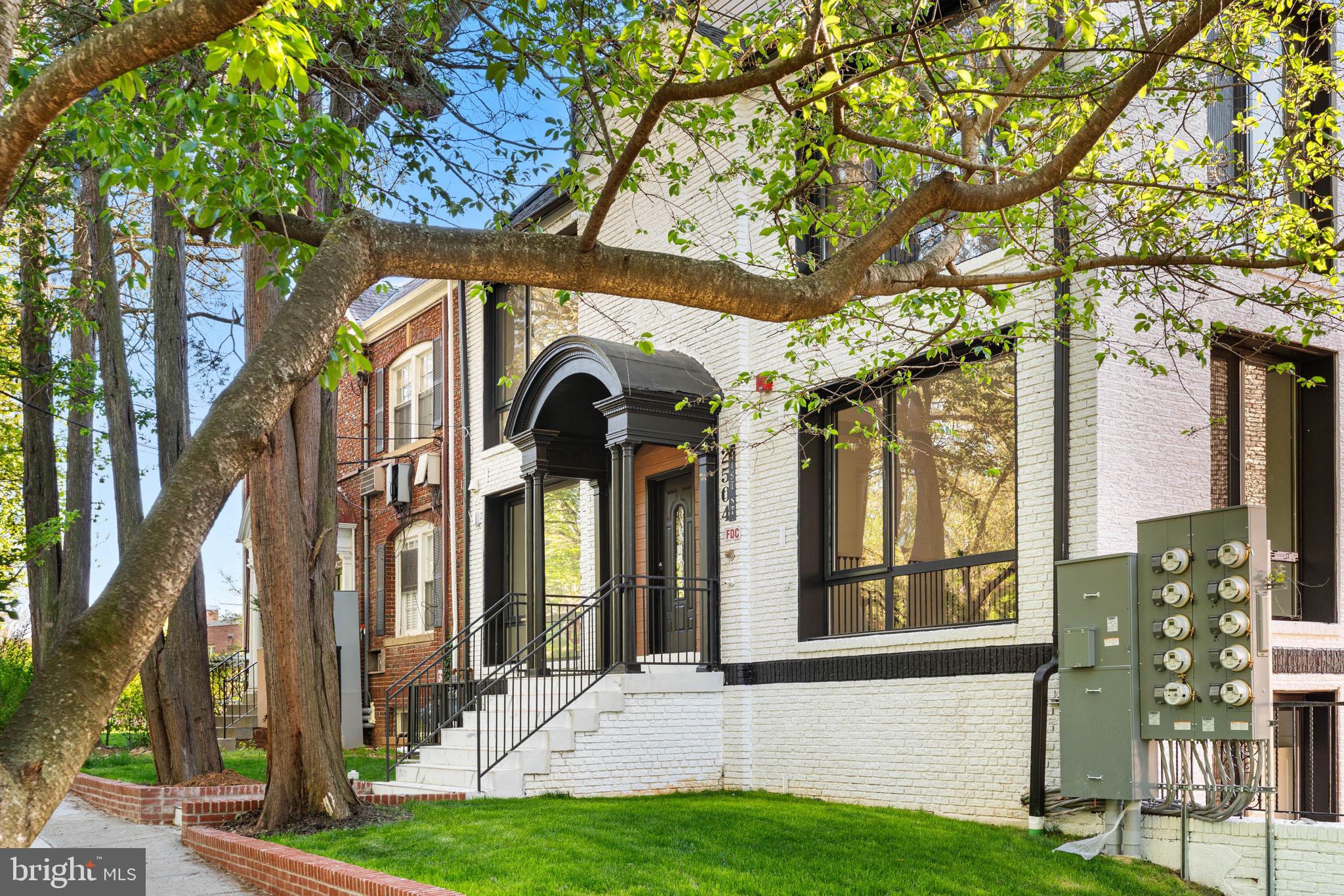 2504 41st Street Northwest, Unit 5 Washington, DC 20007 - Photo 2 of 24 a view of a brick house with a large windows and a tree