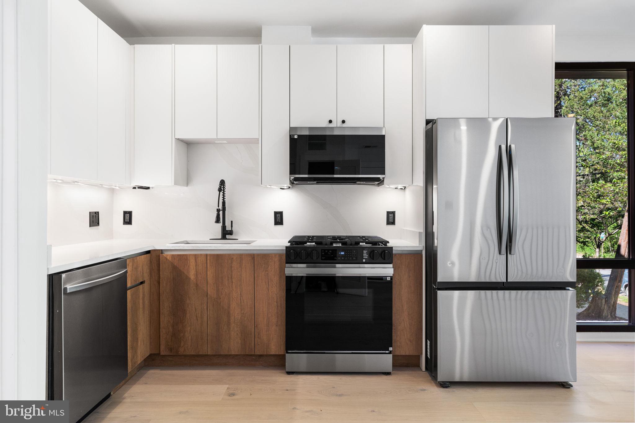 2504 41st Street Northwest, Unit 5 Washington, DC 20007 - Photo 7 of 24 a kitchen with stainless steel appliances a refrigerator stove and sink