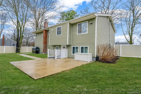 a view of a house with a yard and tree s