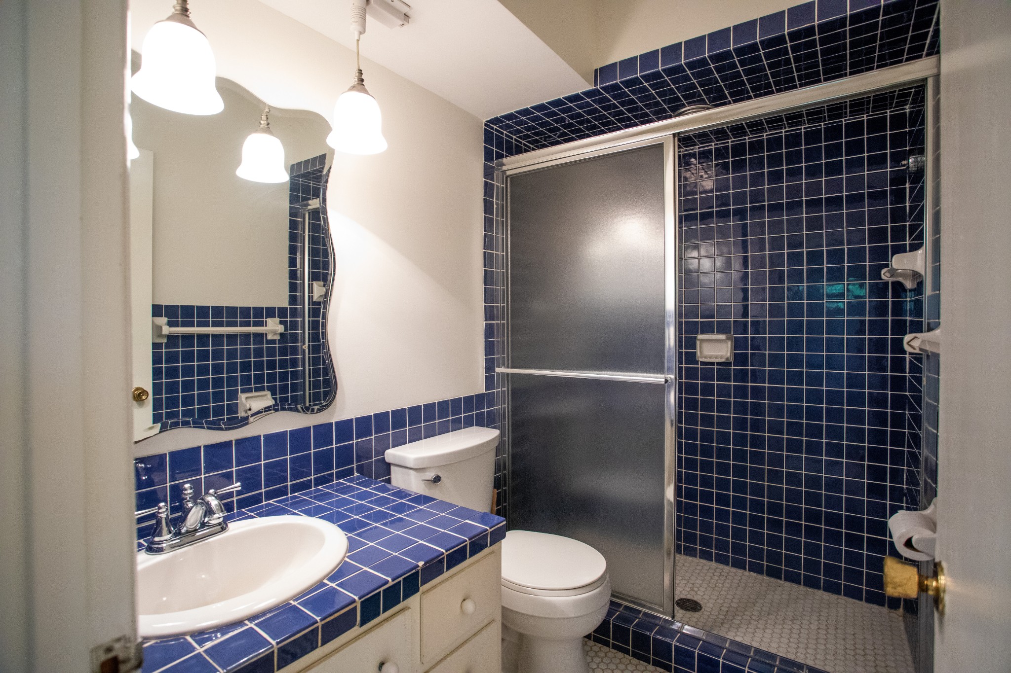 283 Green's View Road Sewanee, TN 37375 - Photo 12 of 50 a bathroom with a sink a toilet a mirror and shower