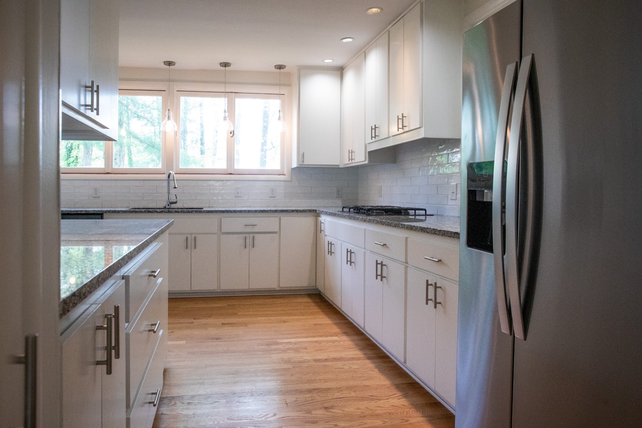 283 Green's View Road Sewanee, TN 37375 - Photo 16 of 50 a kitchen with stainless steel appliances granite countertop a refrigerator a sink dishwasher a stove and white countertops with wooden floor
