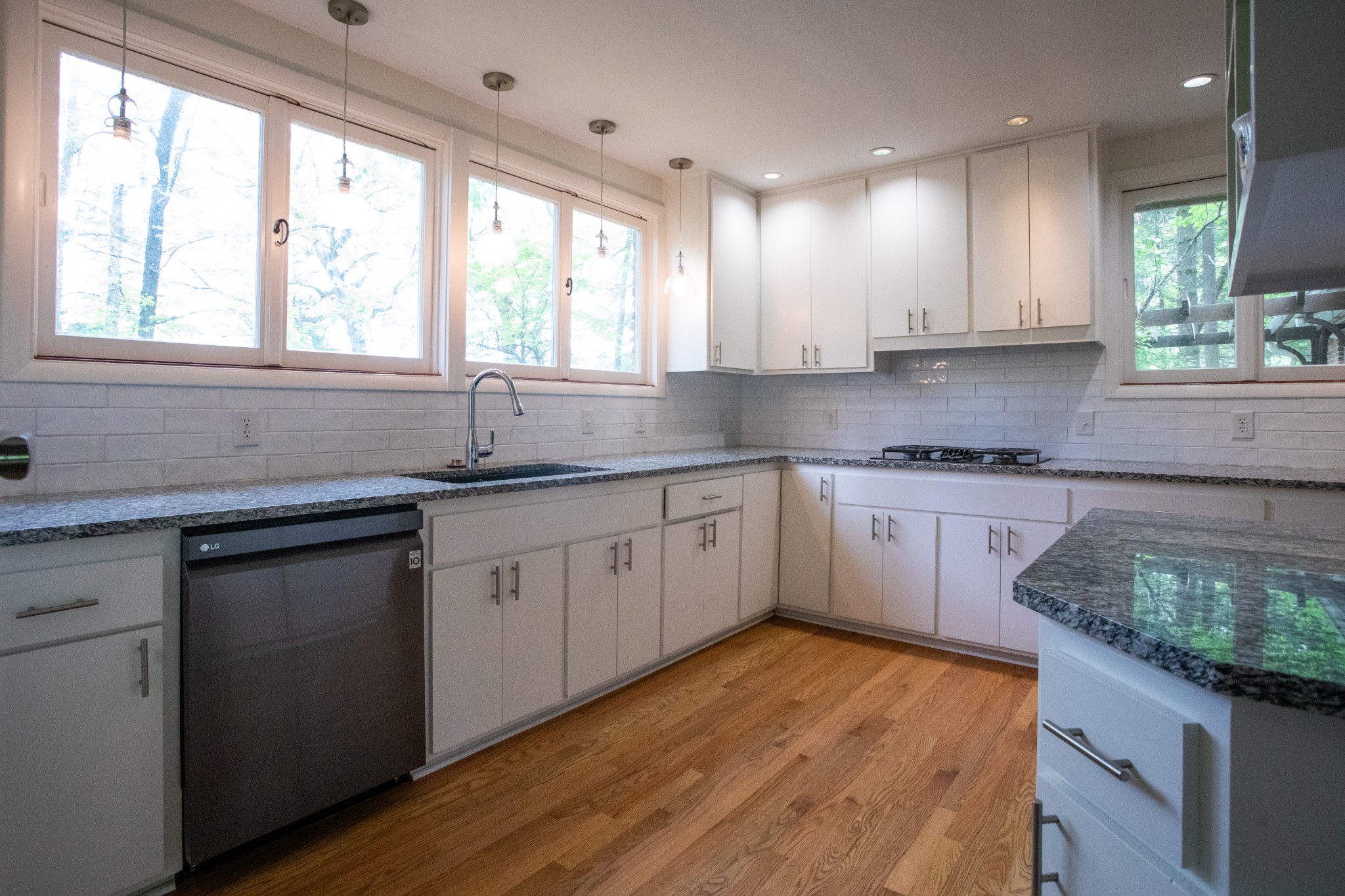 283 Green's View Road Sewanee, TN 37375 - Photo 19 of 50 a kitchen with granite countertop wooden floors and white appliances