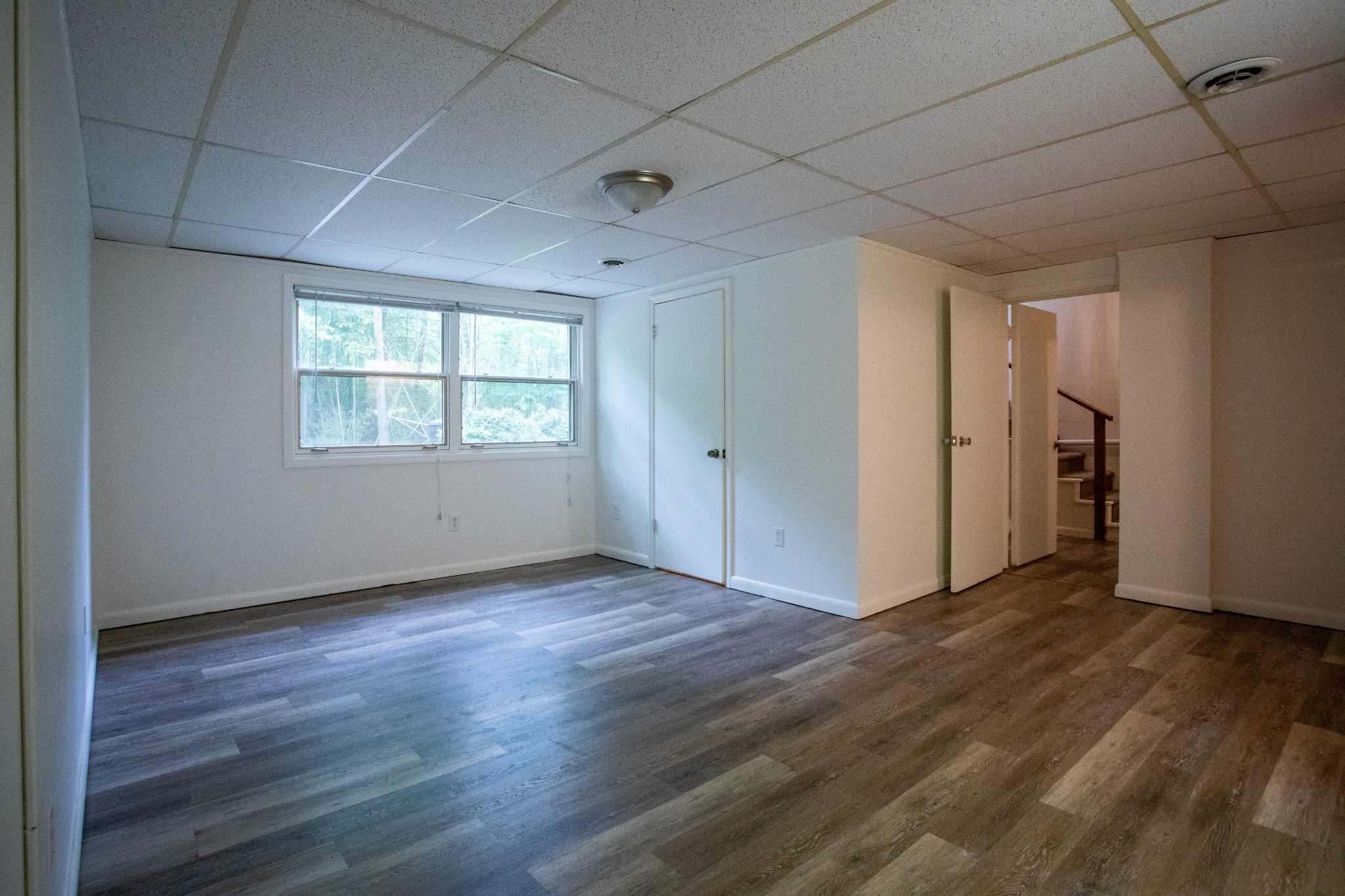 283 Green's View Road Sewanee, TN 37375 - Photo 43 of 50 an empty room with wooden floor and windows