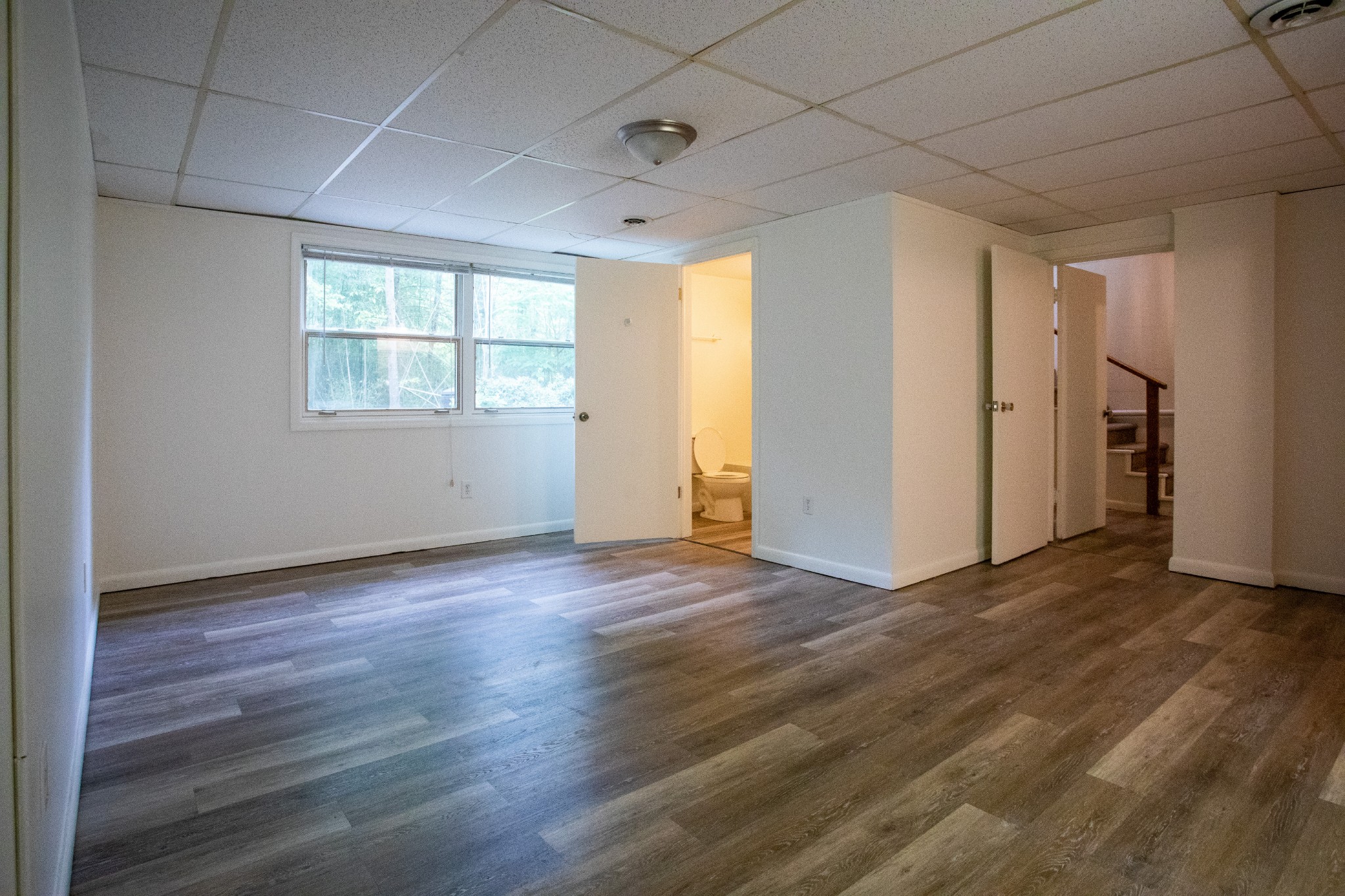 283 Green's View Road Sewanee, TN 37375 - Photo 44 of 50 an empty room with wooden floor and windows