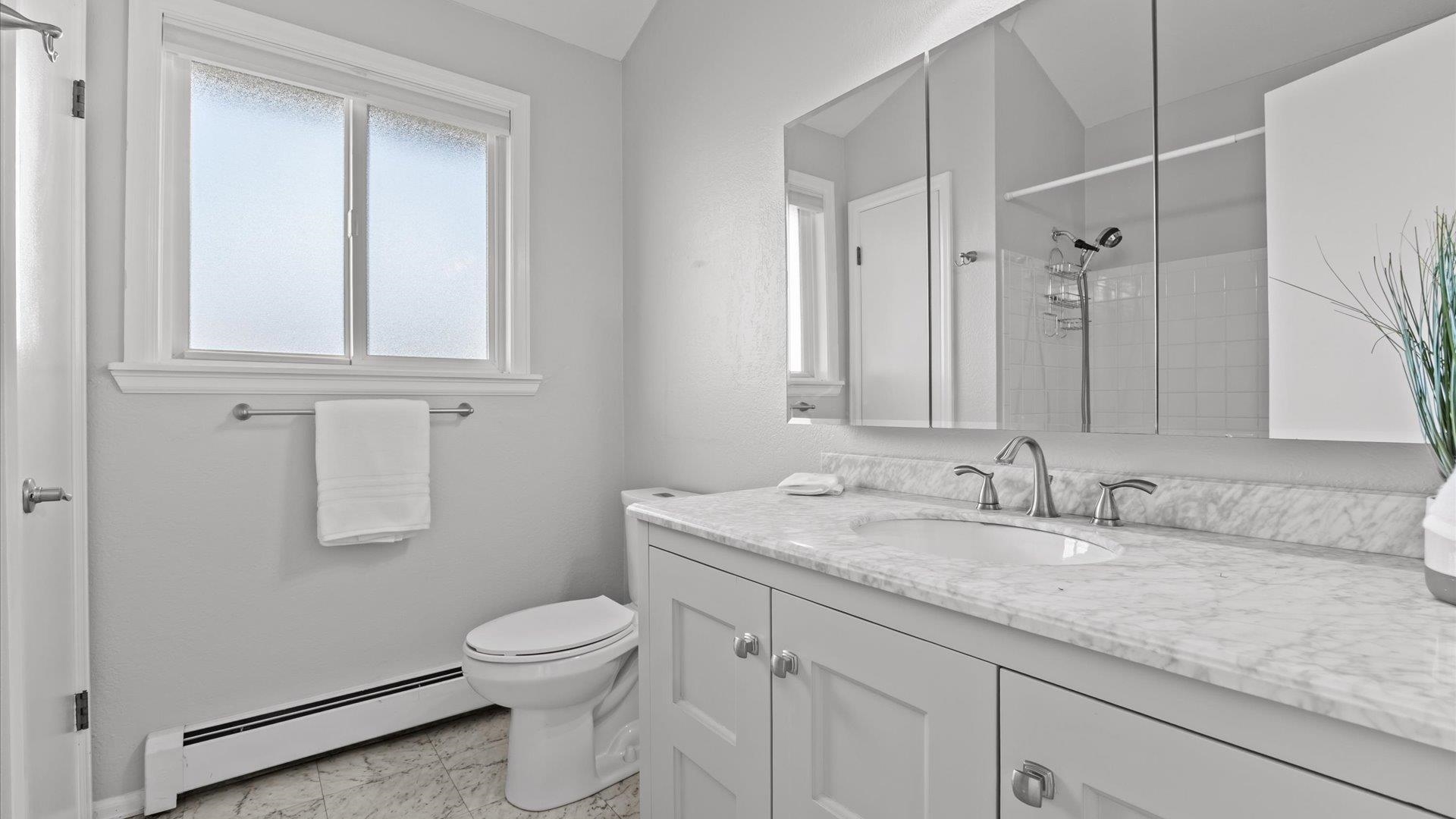 2262 Tanglewood Road Grand Junction, CO 81507 - Photo 20 of 27 a bathroom with a granite countertop toilet a sink and a mirror