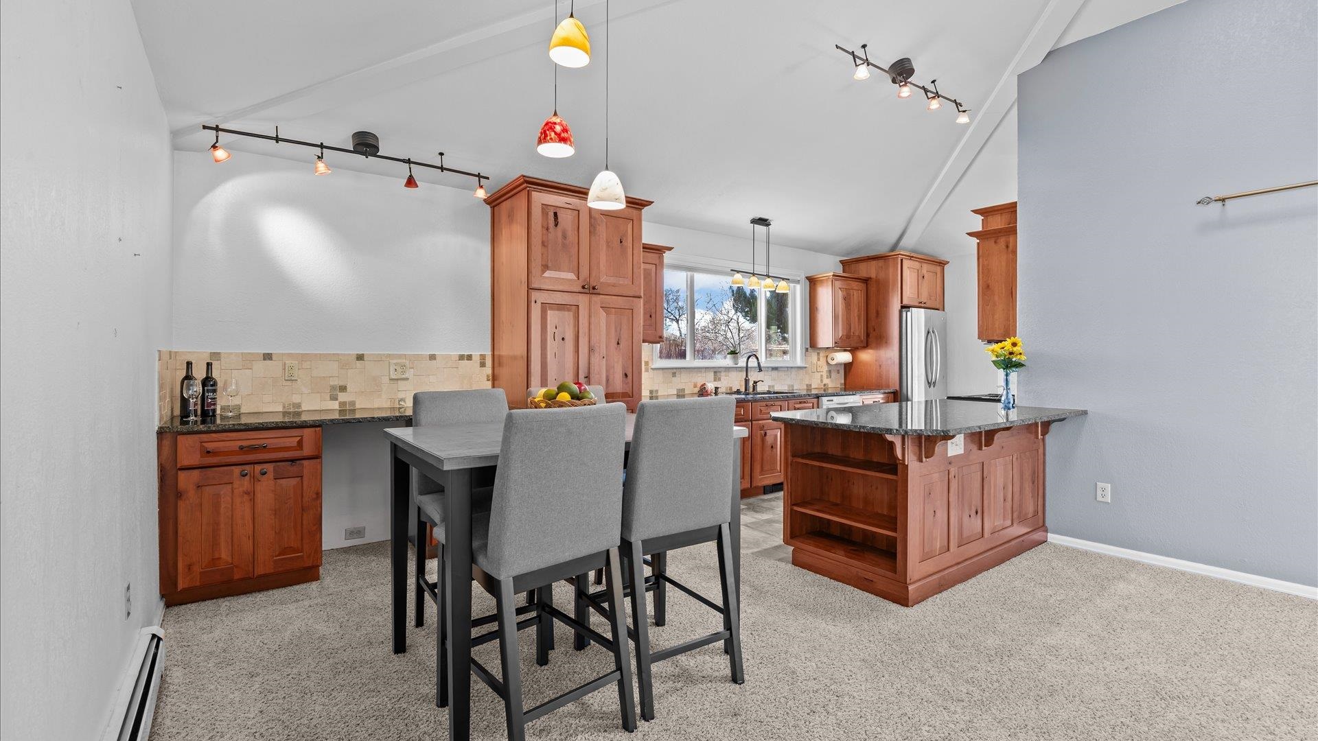 2262 Tanglewood Road Grand Junction, CO 81507 - Photo 8 of 27 a dining hall with stainless steel appliances kitchen island granite countertop furniture and a fireplace