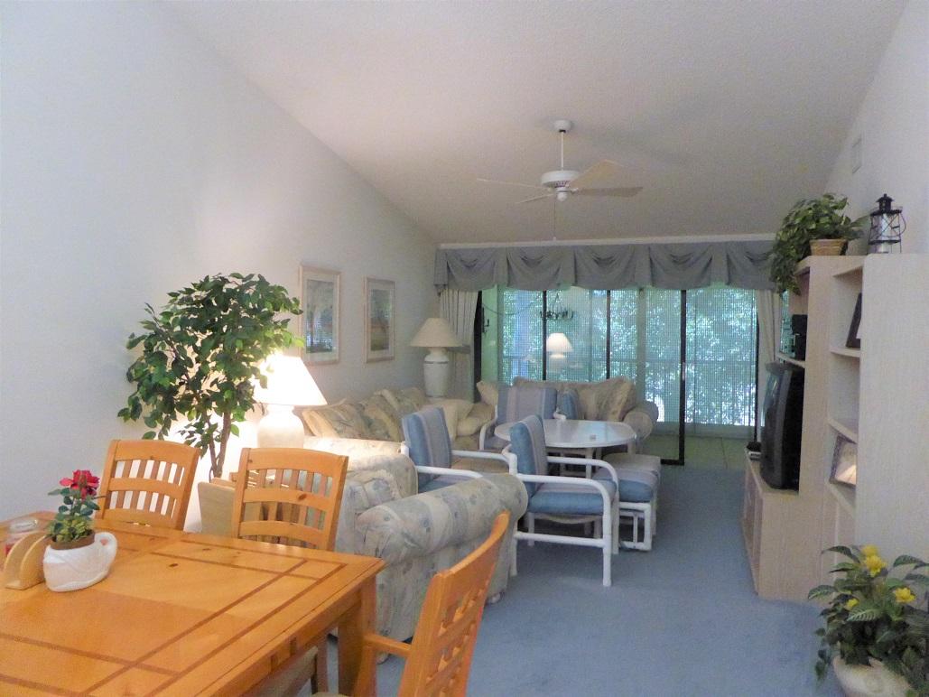 602 Pinecrest Circle, Unit B Jupiter, FL 33458 - Photo 11 of 19 a living room with furniture a flat screen tv and a large window