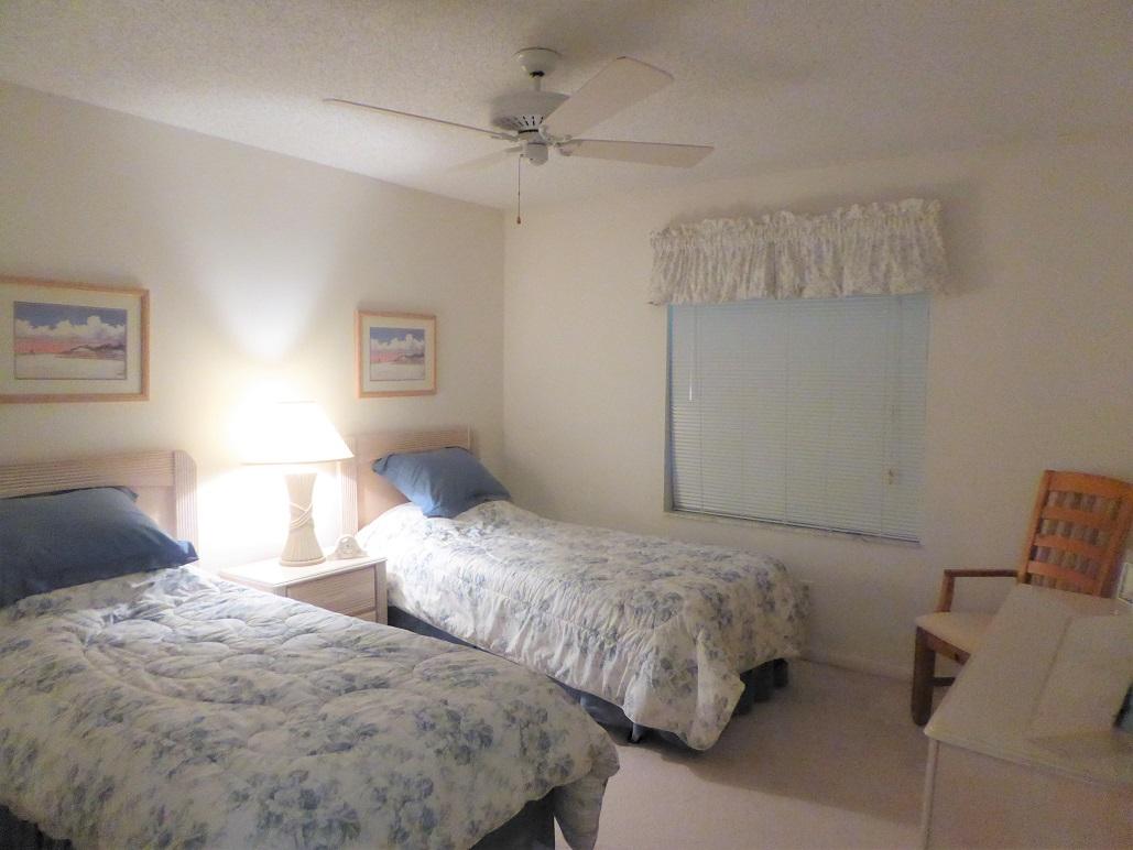 602 Pinecrest Circle, Unit B Jupiter, FL 33458 - Photo 12 of 19 a bedroom with two beds and painted walls