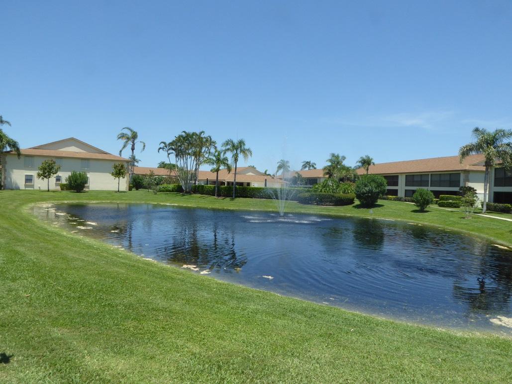 602 Pinecrest Circle, Unit B Jupiter, FL 33458 - Photo 19 of 19 a view of a lake with houses in the background