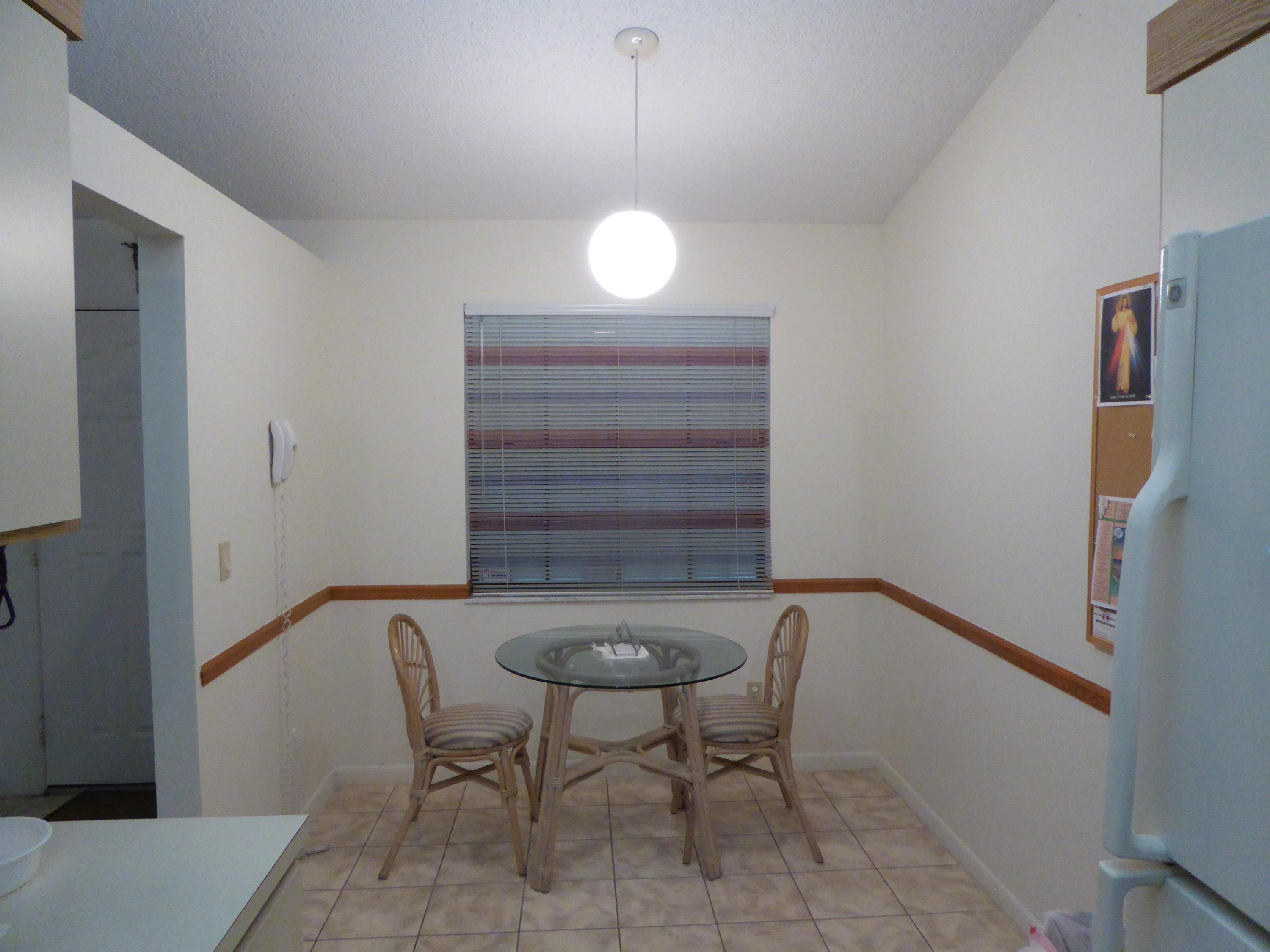602 Pinecrest Circle, Unit B Jupiter, FL 33458 - Photo 5 of 19 a view of a room with a table and chairs