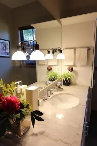 a bathroom with a sink and a mirror