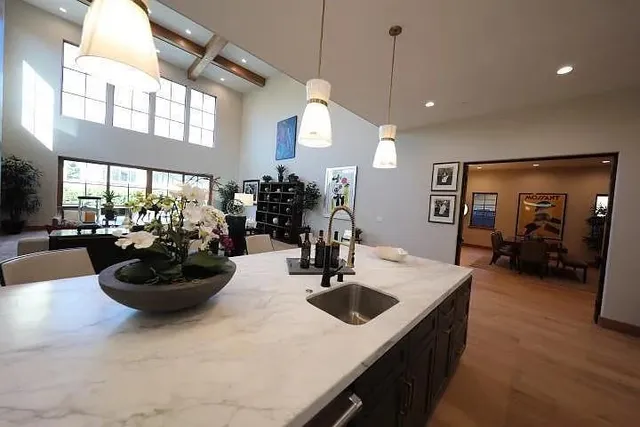 a kitchen with a sink a stove and chairs