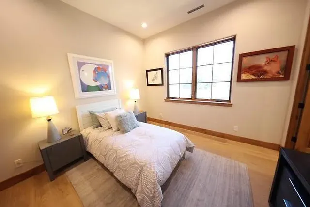 a bedroom with a bed and a window