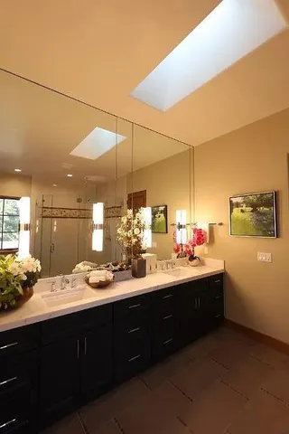 a bathroom with a double vanity sink and mirror